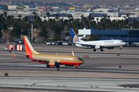  - On blustery winter days when the winds blow from the north, simultaneous landings & departures occur from RWY 01L & 01R, respectively. Continental N12225 is landing on RWY 01R and Southwest N762SW is starting her takeoff roll on RWY 01R. - by Dean Heald