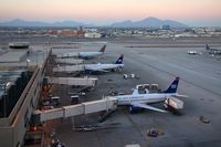  - US Airways / America West aircraft gated at Terminal 4 late in the day. - by Dean Heald