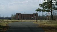  - Inbound road view of one of the hangars, and surrounding grounds - by Paul Perry