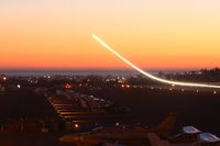 - This was a 30-second exposure of a Gulfstream G-IV N408QS landing on RWY 3. He encountered a 20-kt wind shear on approach to RWY 21 and after several approaches, opted to use RWY 3. - by Dean Heald