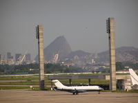  - Biz jet on ramp at Rio. Sugar Loaf Mountian in background. - by John J. Boling