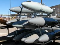  - Spare fuel tanks behind the tarmac during Aviation Nation 2006 at Nellis AFB. - by Brad Campbell