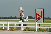 @ Central Nebraska Regional Airport - Cowboy on top of a Lear Jet at the General Aviation Terminal. - by Mark Pasqualino