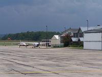  - Taken on the tie down area. This is the Backside of the terminal. In the distance you can see the Civil Air Patrol hangars. - by Frank Wulff III