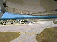  - Departing on 36 - tower and former passenger terminal. - by Bob Simmermon