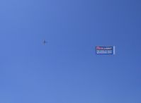  - Can't have an airshow without a beer ad banner tow - by Doug Robertson