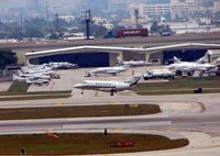  @ Fort Lauderdale/hollywood International Airport - The landing aircraft passes an already busy FBO at FLL - by Terry Fletcher