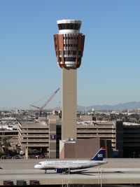  - Good definition of scale between the A319 and the new control tower. The crane in the background is dismantling the old tower. - by John Meneely