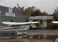  - CP Aviation, FBO offering flight instruction and aircraft maintenance. Hangar and Office. Part of CP's extensive flight line of aircraft on a rare, rainy day. - by Doug Robertson