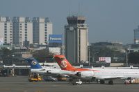  - The old control tower over the domestic terminal with the tail of a F100 from Mandarin Airlines and an MD-90 from Uni Air - by Michel Teiten ( www.mablehome.com )