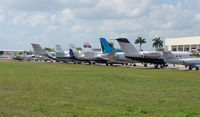  @ Fort Lauderdale Executive Airport - Aview down World Jet's ramp at Ft.Lauderdale Executive reveals a diverse ramp of aircraft types , some of which now fall into the 'classic' category - by Terry Fletcher
