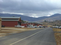  - Huge hangars-not crowded. Ranch barn theme. Note: taxiway is shown, not for landing. - by Doug Robertson