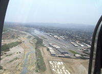 - On base leg for Rwy 22, off airport fire smoke in distance. Note: fire was burning brush, not an aircraft accident - by Doug Robertson