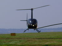  - Robinson R22 hovering near the GA apron - by chrishall