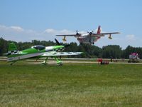  - N65MX & N266GR landing RWY 36 and the controllers in their pretty pink T-shirts. - by Bob Simmermon