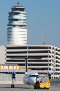 - Dash 8 pushing back in front of ATC tower - by Yakfreak - VAP
