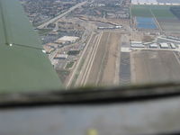  - Displaced threshold chevron markings to 6,013' Rwy 26. Taken from well overhead runway from Beech 36 BONANZA - by Doug Robertson