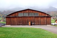  @ LSPG - This former military hangar is now in use by the Kägiswil flying club. - by Joop de Groot
