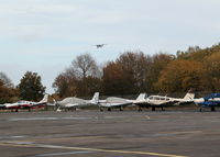  - AIRCRAFT PARKED OUTSIDE MAIN TERMINAL. AIRCRAFT ABOVE TREES APPROACHING RUNWAY 25 - by BIKE PILOT