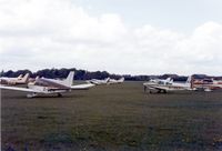  @ EGTI - A 2nd view across Leavesden airfield with the competitors gathered for the start of the London to Londonderry Air Race of 1983 - by GeoffW