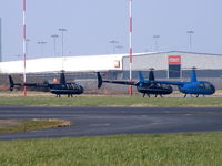  - a lineup of Robinson R44's - by Chris Hall