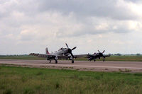  - Skyraider and Bearcat taxi on the runway at the 1987 Waco Airshow - by Zane Adams