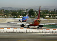  - The old (N349SW) and the new (N907WN) face off for rights to Runway 24L - winglets and new colors won! - by Steve Nation