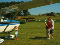  - Getting a pose in front of a vintage Cessna at the Father's Day fly-in. - by Megan Simmermon