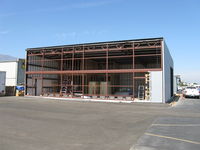  - New hangar under construction. Insulated, internal wall studs, framing for two-story rooms in corner - by Doug Robertson