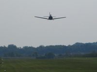  - T28 making a high speed pass during the EAA fly-in. - by Bob Simmermon