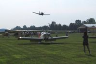  - T28 making a high speed pass during the EAA fly-in. - by Bob Simmermon