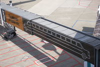  - Humoristic ad on jetways in Düsseldorf. The stretching of the jetway, transforms a normal sedan car into a limo. Which is a perfect illustration of what the company offers. - by Philippe Bleus