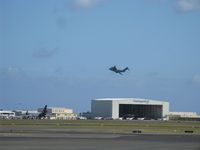  - A view of the cargo ramp and CO hangar, complete with a C-5 taking off beyond it. - by Kreg Anderson