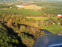  @ Lowell City Airport - Final for the hard surface (30). Tall obstacles on each end. - by Bob Simmermon