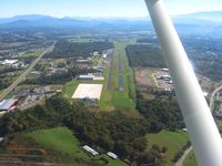  - Looking east down RWY 10.  The large concrete ramp is the FBO's new location. - by Bob Simmermon