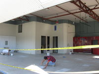  - 32 Curtiss Taxi-New hangar under construction. Tile floor installation. - by Doug Robertson