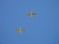  - Two Ryan ST-3KRs as PT-22s, N58651 #38 and N53271 #596 (in lead) overhead formation with wonderful 5 cylinder Kinner radial rumbles. - by Doug Robertson