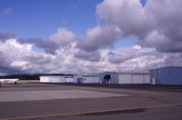  - Small hangars on the East Ramp near Concord. Pilots lounge at the blue awning.  - by Bill Larkins
