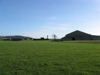  - Former RAF Pembrey airfield technical site. Remaining buildings, one (of two) F type hangar and the land turned over to agricultural use - by Roger Winser