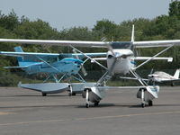  - VISITING CESSNA 206H N206MX AND RESIDENT CESSNA 182R G-ESSL TAXYING FOR DEPARTURE - by BIKE PILOT