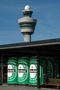  - Schiphol control tower and an add for an average Dutch beer as seen from the observation platform. - by Henk van Capelle