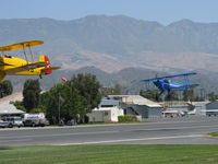  - N131MR and N104A in tandem takeoff Rwy 22 at the National Bucker fly-In. (I need a wider angle lens) - by Doug Robertson