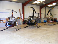  - Robinson R22 and R44 helicopters in the Heli Air hangar at Wellesbourne Mountford - by Chris Hall