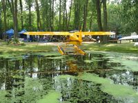 - A view of a Cub and some exhibitors behind it at the Vette/Blust Seaplane Base. - by Kreg Anderson