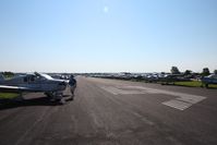  @ Fond Du Lac County Airport - Looking east down RWY 9 as temporary parking ramp during Oshkosh 2010. - by Bob Simmermon