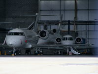  - Biz jets inside the Signature Flight Support hangar - by Chris Hall