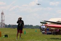  - A little fellow watching a C-17A (01-0192) arrive at Airventure 2010 - Oshkosh, Wisconsin - by Bob Simmermon