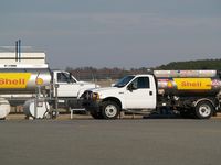  @ Wayne Executive Jetport Airport - AvGas Truck (right) and JET A Truck (left) at Goldsboro-Wayne - by George Zimmerman