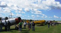  - A view of the warbird lineup at the 4th annual Gerry Beck Memorial Fly-in in Battle Lake, MN. - by Kreg Anderson