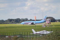  - TUI 737 taxi's in whilst a Cherokee awaits departure. - by Graham Reeve